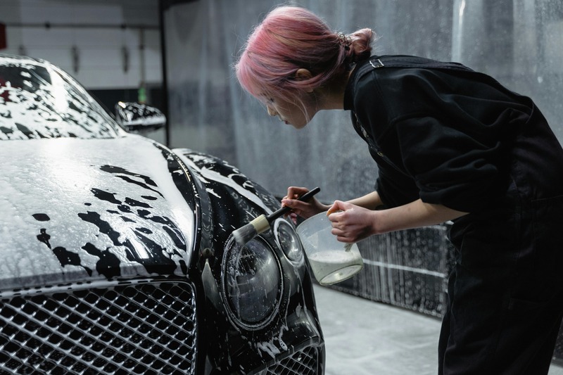 Professional cleaning of car interior during mobile detailing service